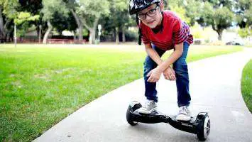 kid standing on a hoverboard